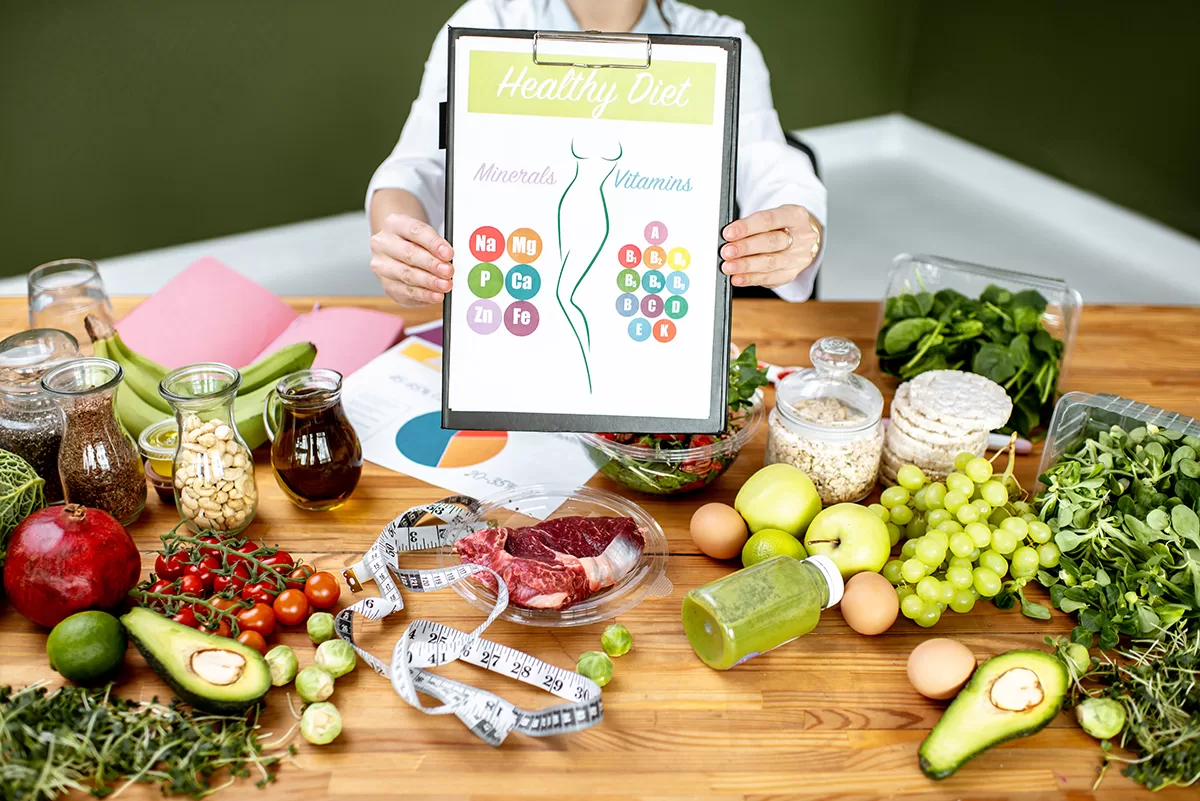 dietitian with vitamin sheme at the table full of 2023 11 27 04 51 43 utc copy